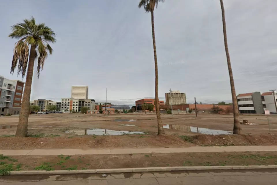 Google street view of vacant lot in Phoenix, Arizona with palm trees in foreground